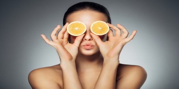 A person holding slices of oranges over her eyes AI-generated content may be incorrect.